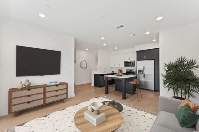 TV console kitchen island and living area living room at Ascent at Campus of Life in San Diego Student Accommodation