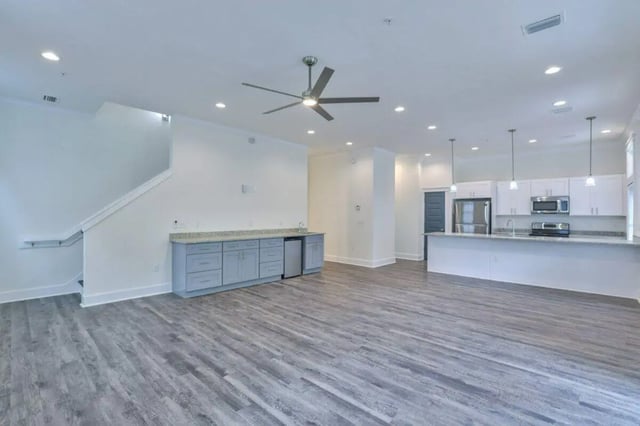 Kitchen island cabinets refrigerator microwave living room at Ashburn Hills Townhomes in Tallahassee Student Accommodation