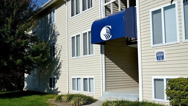 Building with blue awning and windows exterior at Collegiate Court in Blacksburg Student Accommodation