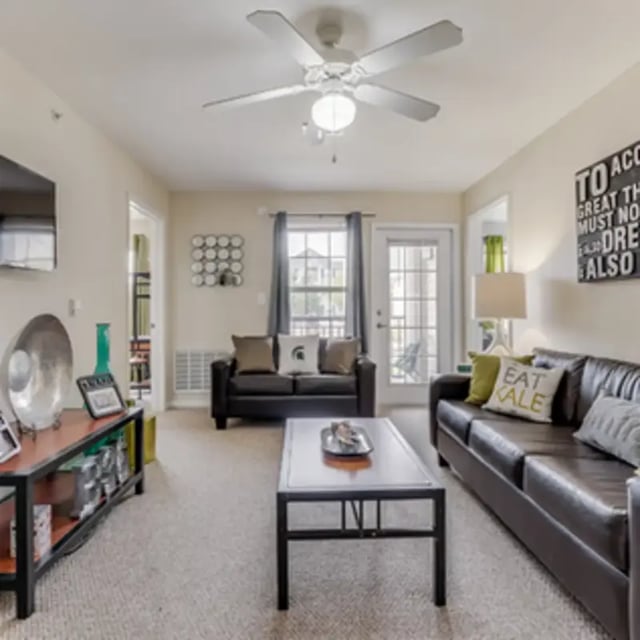 Two leather couches coffee table living room at Block 36 - Lease by Bed Available in East Lansing Student Accommodation