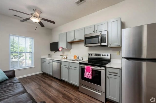 Kitchen with cabinets microwave oven stove and refrigerator kitchen at 120 Flats in West Lafayette Student Accommodation