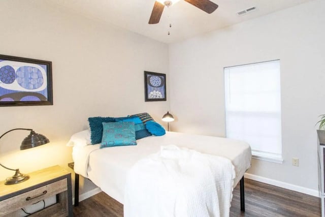 Bed with blue pillows and artwork bedroom at 120 Flats in West Lafayette Student Accommodation