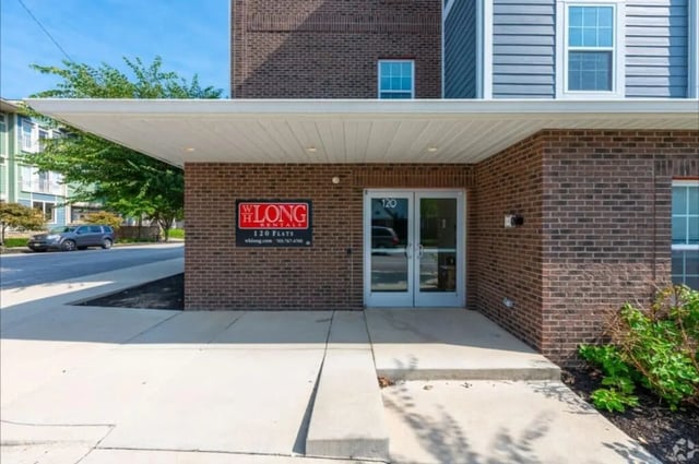 Brick building entrance with double doors and signage exterior at 120 Flats in West Lafayette Student Accommodation