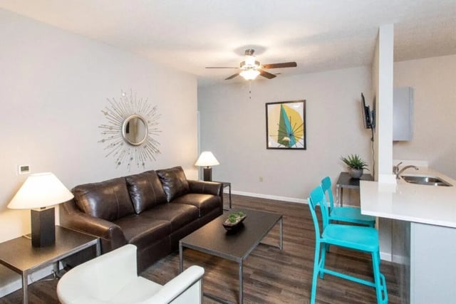 Brown sofa coffee table two chairs kitchen living room at 120 Flats in West Lafayette Student Accommodation