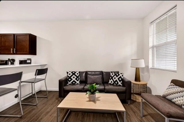 Sofa coffee table bar stools living room at Cedar Flats Apartments in Chico Student Accommodation