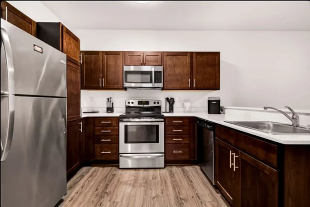 Stainless steel refrigerator stove microwave dark cabinets kitchen at Cedar Flats Apartments in Chico Student Accommodation