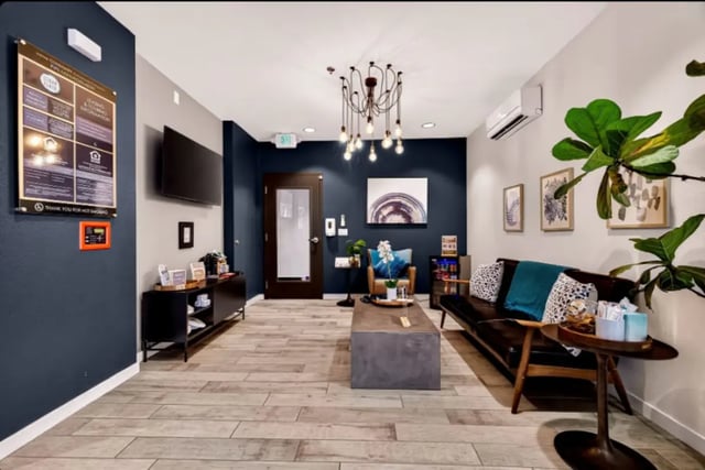 Lounge area with seating and modern chandelier. Lounge area. at Cedar Flats Apartments in Chico Student Accommodation