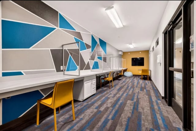 Desks chairs and protective screens study area at Cedar Flats Apartments in Chico Student Accommodation