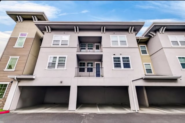 Apartment building with balconies and parking exterior at Cedar Flats Apartments in Chico Student Accommodation
