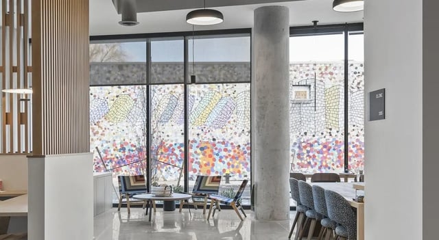 Colorful abstract art windows chairs table lounge at 525 Linc in Boston Student Accommodation