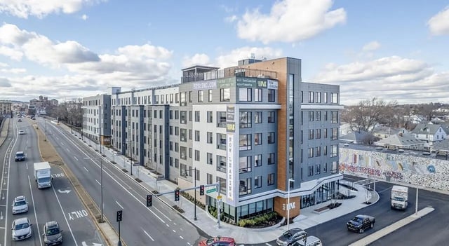 Modern building with signs advertising apartments exterior at 525 Linc in Boston Student Accommodation