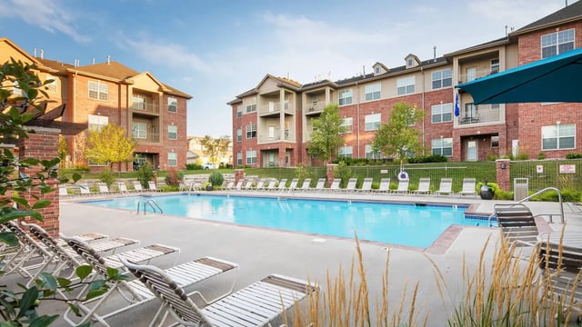 Apartment buildings with pool and lounge chairs Exterior at Broadmoor Hills in Omaha Student Accommodation
