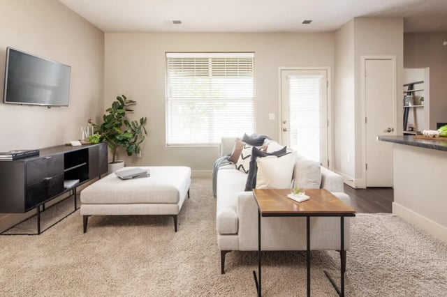 Living room with sofa ottoman and TV living room at Broadmoor Hills in Omaha Student Accommodation
