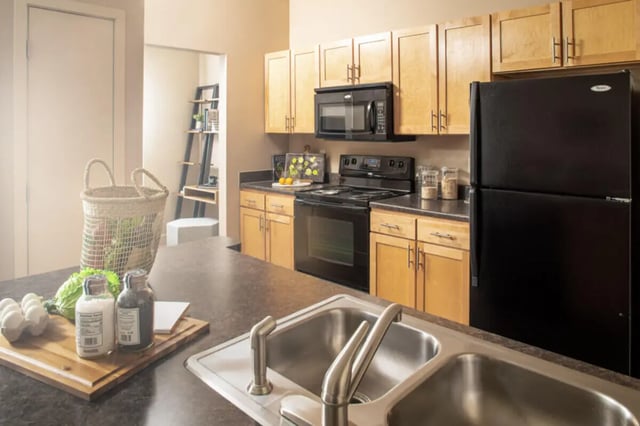 Sink produce basket microwave oven refrigerator kitchen at Broadmoor Hills in Omaha Student Accommodation