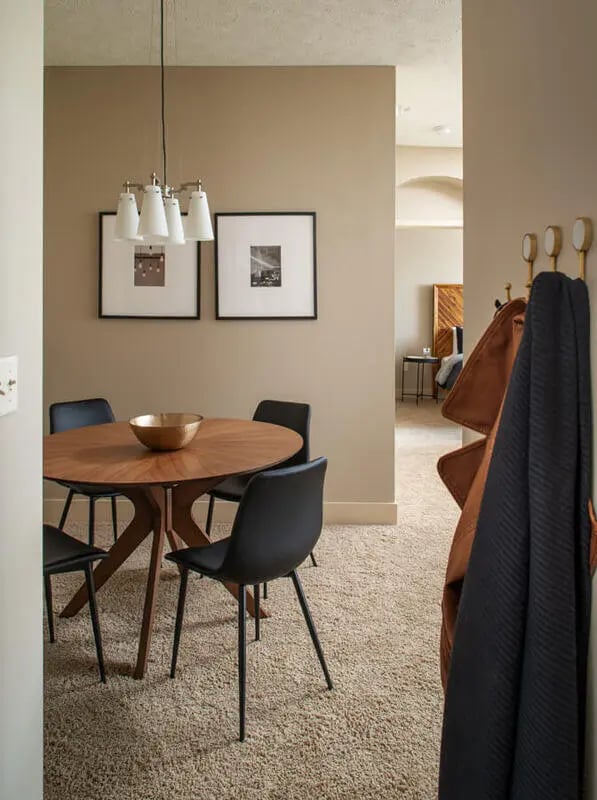 Round table chairs framed art hanging light dining room at Broadmoor Hills in Omaha Student Accommodation