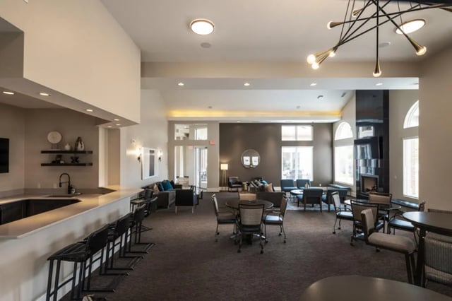 Bar counter with stools and lounge seating living room at Broadmoor Hills in Omaha Student Accommodation