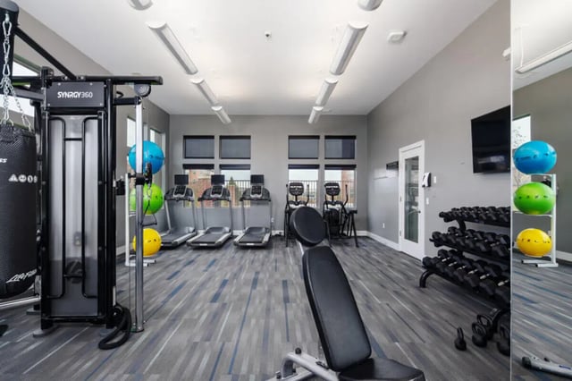 Gym with treadmills weight rack and punching bag gym at Broadmoor Hills in Omaha Student Accommodation