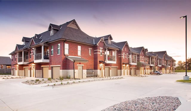 Brick townhouses with garages and balconies exterior at Broadmoor Hills in Omaha Student Accommodation