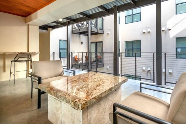 Outdoor seating area with chairs and bar counter patio at Villas on 26th in Austin Student Accommodation