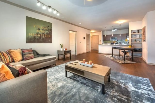 Sofa coffee table and kitchen area living room at Villas on 26th in Austin Student Accommodation