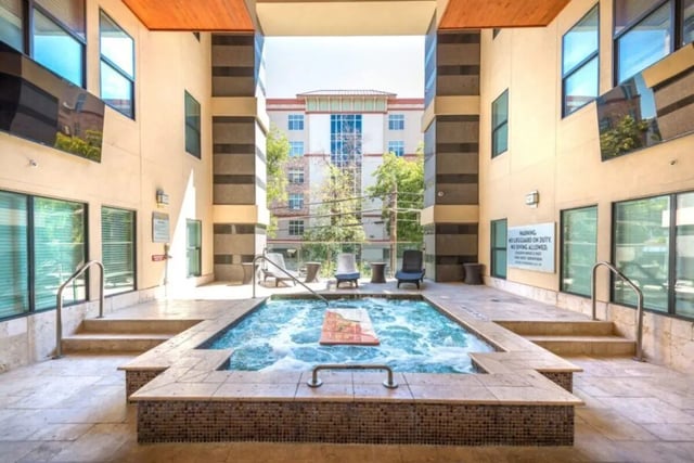 Hot tub and lounge chairs exterior view at Villas on 26th in Austin Student Accommodation