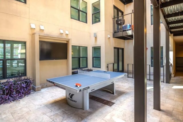 Ping pong table with paddles and television playing area at Villas on 26th in Austin Student Accommodation