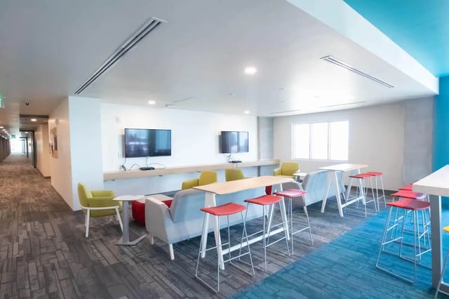 Modern seating two TVs hallway living room at UnionWest Student Living in Orlando Student Accommodation