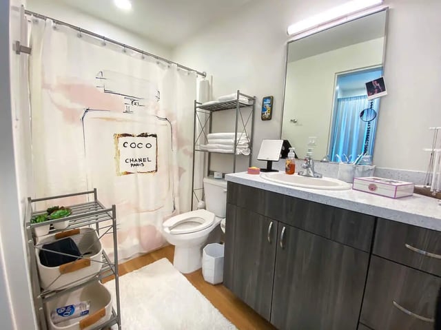 Shower curtain toilet shelves counter sink bathroom at UnionWest Student Living in Orlando Student Accommodation