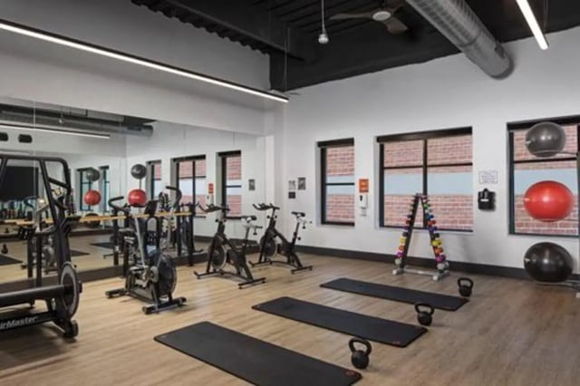 Gym equipment weights mats exercise bikes fitness area at Vic Village North in Ann Arbor Student Accommodation