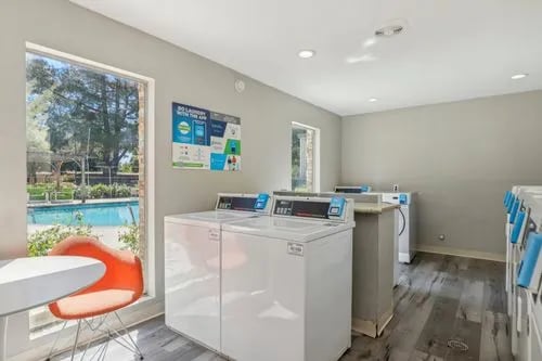 Washing machines and dryers in laundry room at The Spoke in Davis Student Accommodation