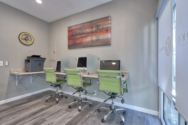 Computers printers and green chairs study area at The Spoke in Davis Student Accommodation