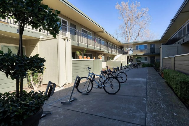 Bicycles parked in front of apartment buildings exterior at The Spoke in Davis Student Accommodation