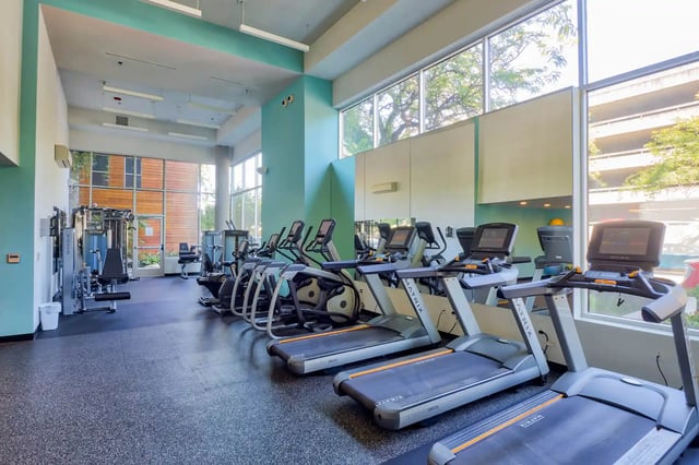 Row of treadmills and weight machines gym at The Soto in Eugene Student Accommodation