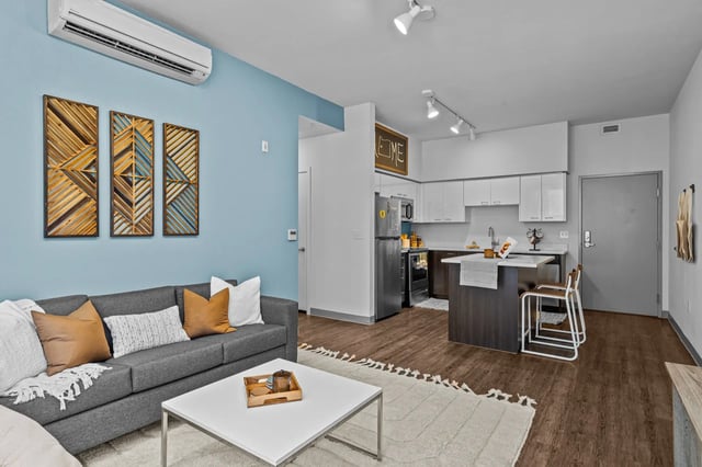 Sofa kitchen island and air conditioner living room at The Soto in Eugene Student Accommodation