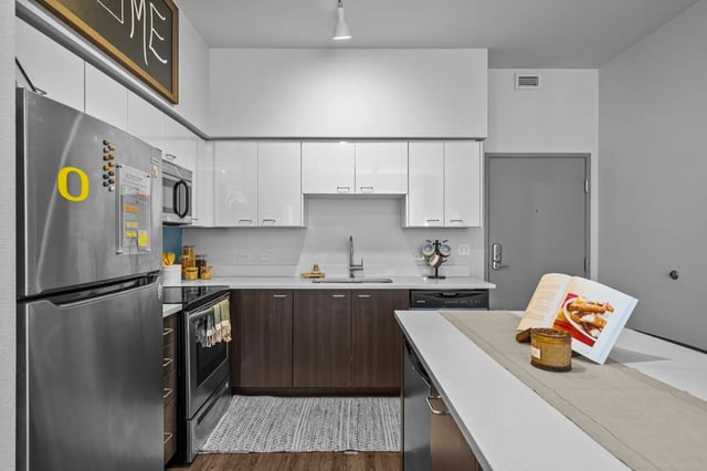 Modern kitchen with stainless steel fridge and cabinets kitchen at The Soto in Eugene Student Accommodation