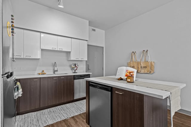 Modern kitchen with white cabinets island and dishwasher kitchen at The Soto in Eugene Student Accommodation
