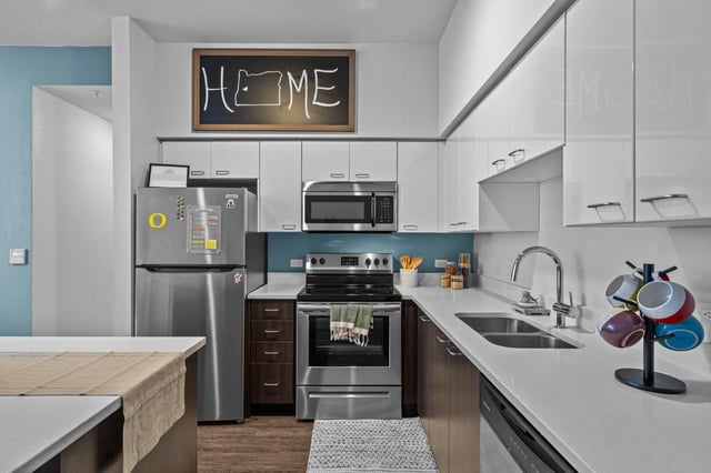 Modern kitchen with stainless steel appliances and chalkboard art kitchen at The Soto in Eugene Student Accommodation