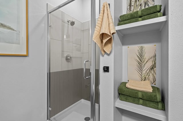 Glass shower stall with towels and art Bathroom at The Soto in Eugene Student Accommodation