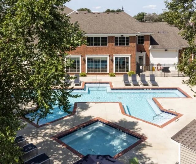 Pool with lounge chairs and building exterior at University Edge South Bend in South Bend Student Accommodation