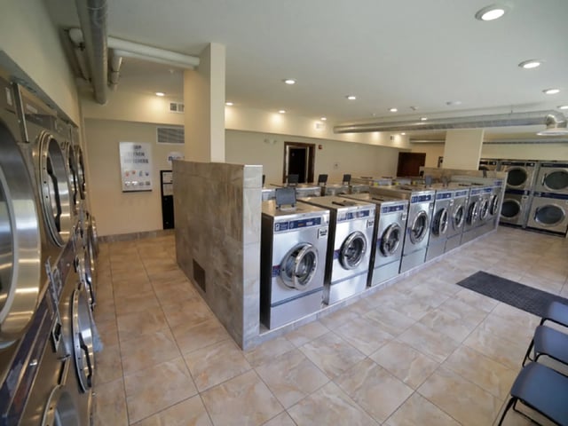 Multiple rows of washing machines and dryers laundry room at The Grove at Mankato in Mankato Student Accommodation