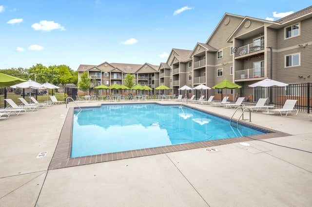 Apartment complex pool with lounge chairs exterior at The Grove at Mankato in Mankato Student Accommodation