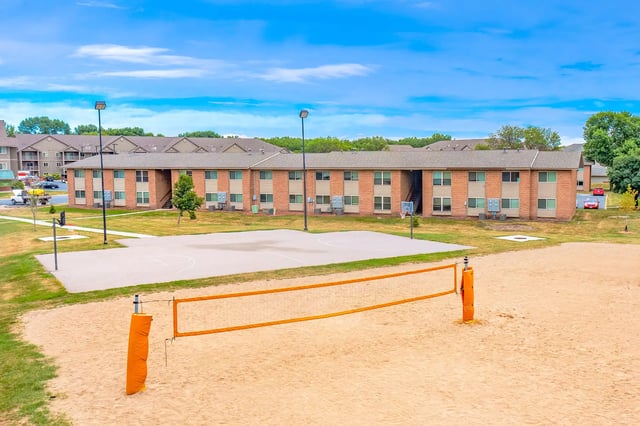 Volleyball court basketball court apartment building exterior at The Grove at Mankato in Mankato Student Accommodation