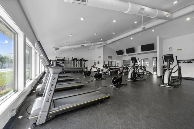 Treadmills ellipticals and bikes in gym playing area at The Grove at Mankato in Mankato Student Accommodation