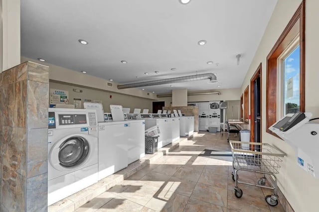 Washing machines and dryers in communal laundry area at The Grove at Mankato in Mankato Student Accommodation