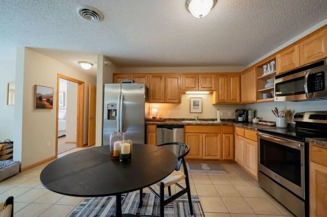 Round table stainless steel refrigerator kitchen appliances kitchen at The Grove at Mankato in Mankato Student Accommodation