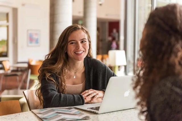 Smiling student with laptop study area at The Douglas - Student Housing Apartments in Seattle Student Accommodation