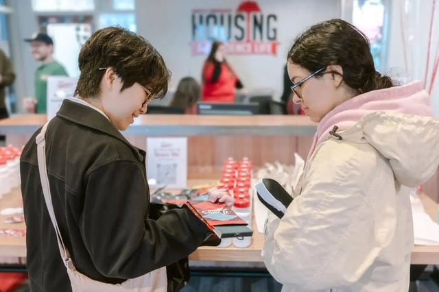 Two students examine materials at a desk. at The Douglas - Student Housing Apartments in Seattle Student Accommodation