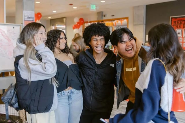 Students laughing together in communal area at The Douglas - Student Housing Apartments in Seattle Student Accommodation