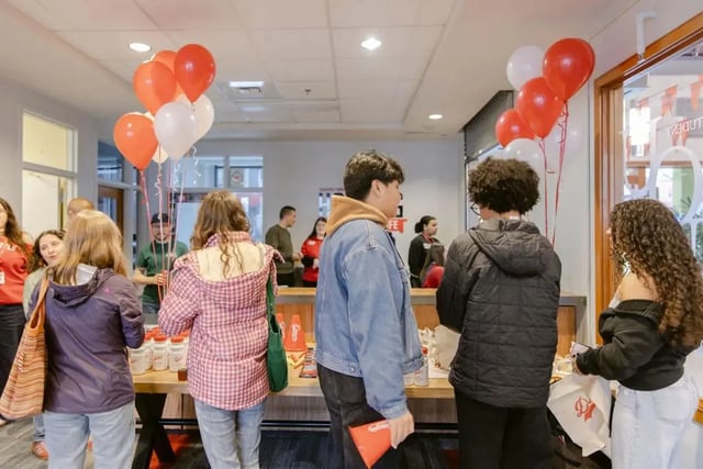 Students gather around a table with balloons exterior at The Douglas - Student Housing Apartments in Seattle Student Accommodation