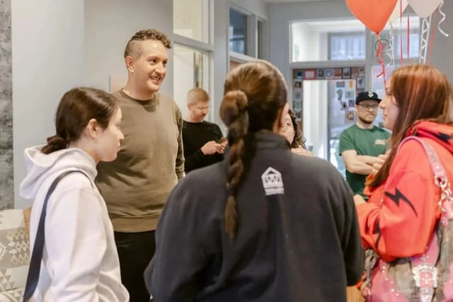 Students gathered talking inside communal living area at The Douglas - Student Housing Apartments in Seattle Student Accommodation